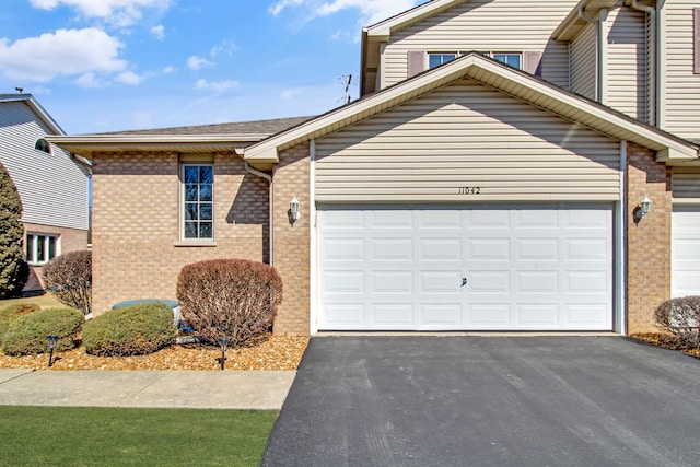 11042 Quail Dr, Mokena, IL 60448 - view of front of house featuring driveway, an attached garage, and brick siding