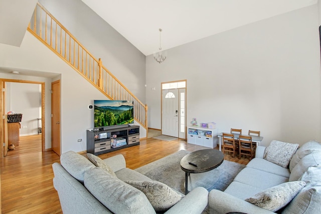 11042 Quail Dr, Mokena, IL 60448 - living room featuring a high ceiling, baseboards, stairway, and wood finished floors