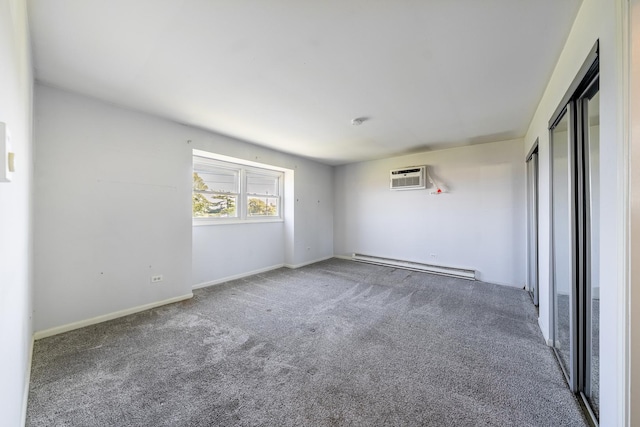 empty room featuring baseboards, an AC wall unit, a baseboard heating unit, and carpet flooring