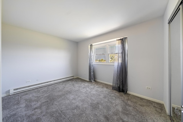 unfurnished bedroom featuring a closet, carpet, baseboards, and a baseboard heating unit