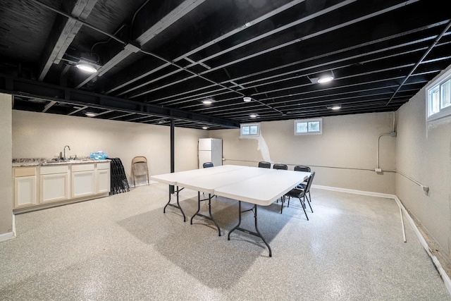 game room featuring baseboards and a sink