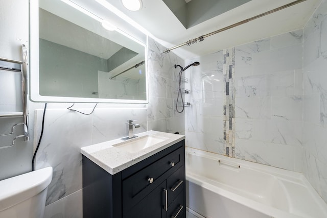 bathroom with vanity, tile walls, toilet, backsplash, and tub / shower combination