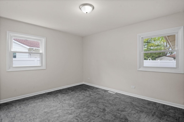 769 Bonita Ave, Elk Grove Village, IL 60007 - unfurnished room with dark carpet and baseboards