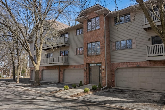 view of property with driveway and an attached garage