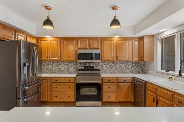 kitchen with light countertops, a sink, stainless steel appliances, and backsplash