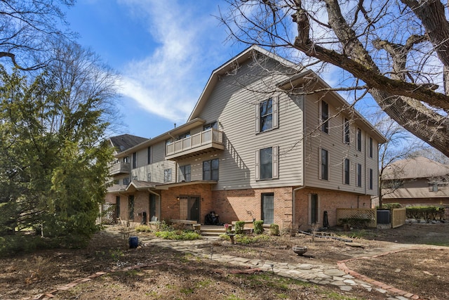 view of front of house with brick siding and central AC unit
