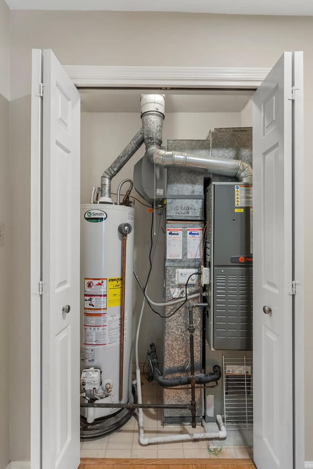 utility room featuring water heater