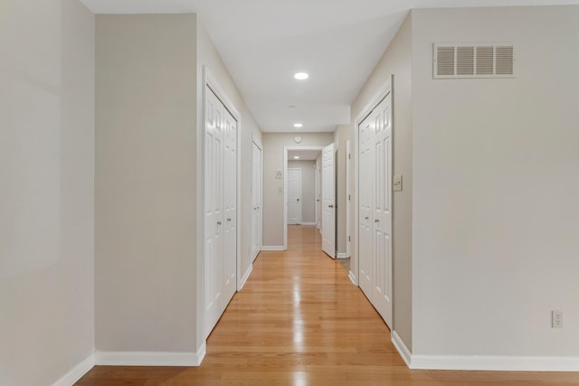 corridor with recessed lighting, baseboards, light wood-style floors, and visible vents