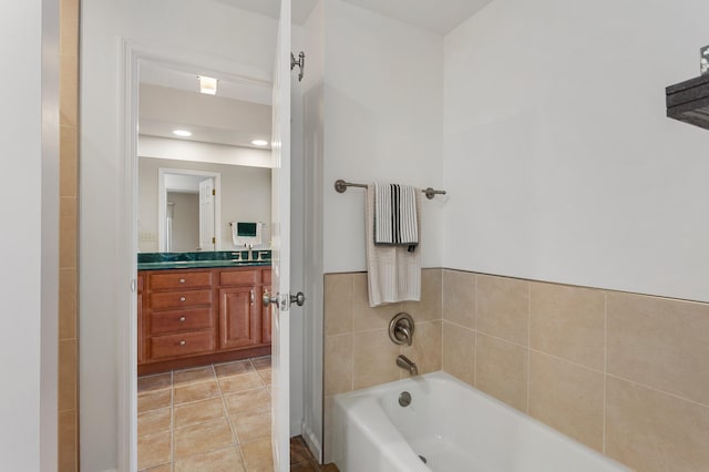 full bathroom featuring a garden tub, tile patterned floors, and vanity