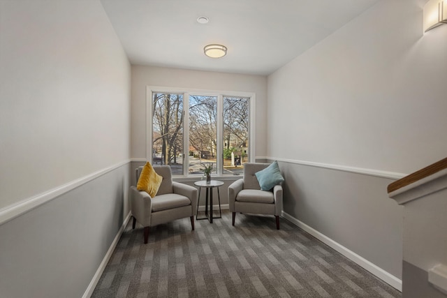 sitting room with baseboards and carpet floors