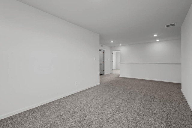 unfurnished room with baseboards, visible vents, recessed lighting, and light carpet
