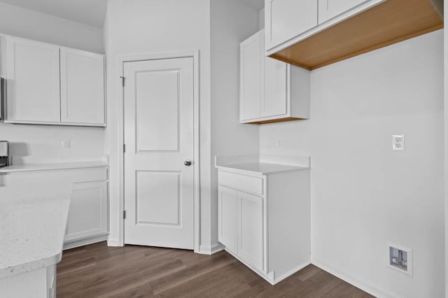 kitchen featuring baseboards, white cabinets, and dark wood finished floors