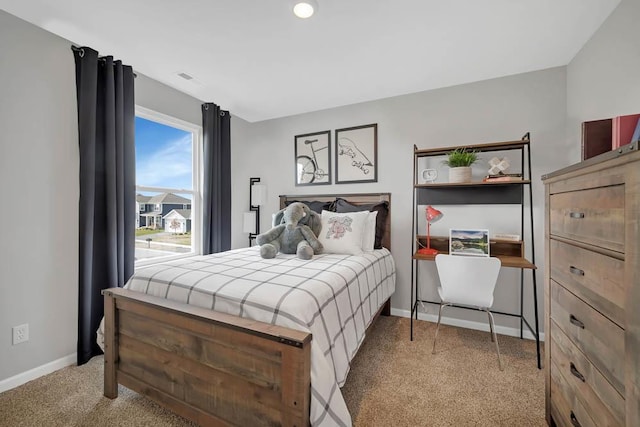 bedroom with light carpet and baseboards