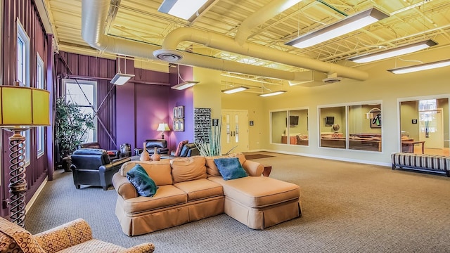 interior space with carpet flooring, a healthy amount of sunlight, baseboards, and visible vents