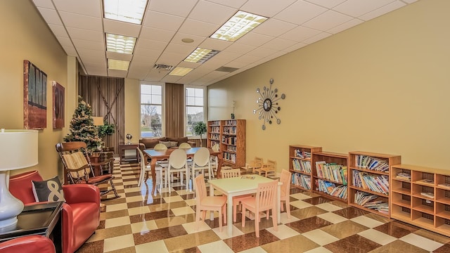 interior space with visible vents, a drop ceiling, and tile patterned floors
