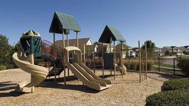 community playground featuring a residential view and fence