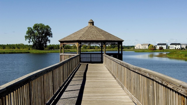 surrounding community with a water view and a gazebo