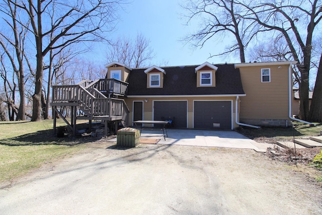 view of front of property with dirt driveway, an attached garage, stairway, and a front yard