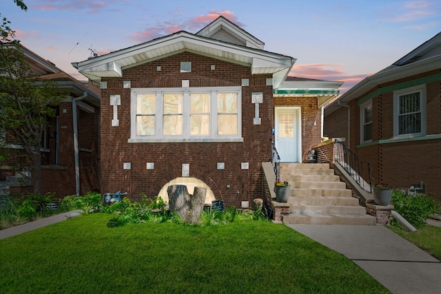 view of front of property featuring a front yard and brick siding