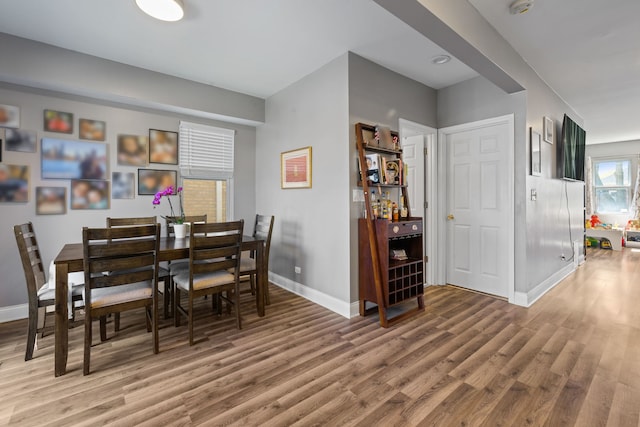 dining room featuring baseboards and light wood-type flooring
