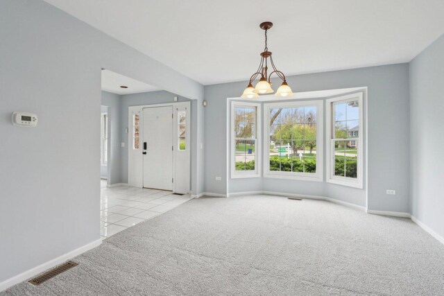 interior space with visible vents, carpet, and baseboards