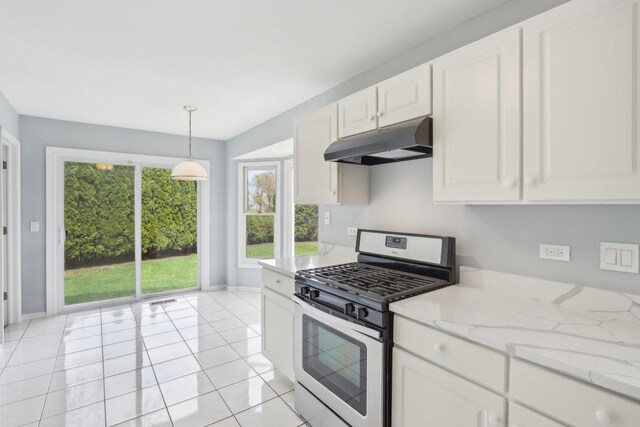 kitchen featuring baseboards, under cabinet range hood, white cabinets, and stainless steel gas stove