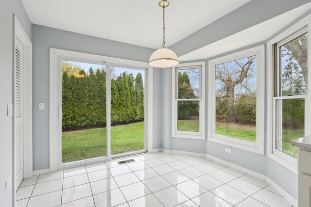 unfurnished dining area with visible vents, baseboards, and light tile patterned floors