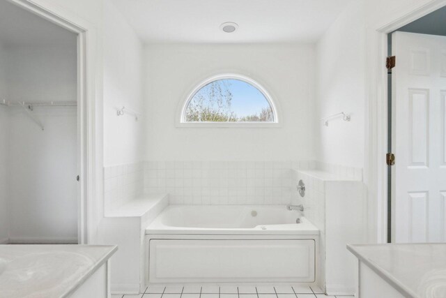 full bath with vanity, tile patterned flooring, and a garden tub