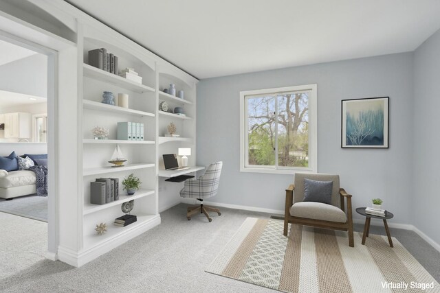 carpeted office space featuring baseboards and built in features