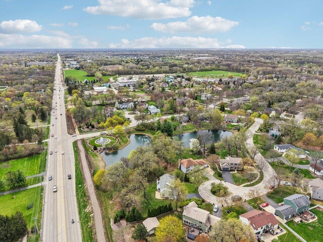birds eye view of property with a water view and a residential view