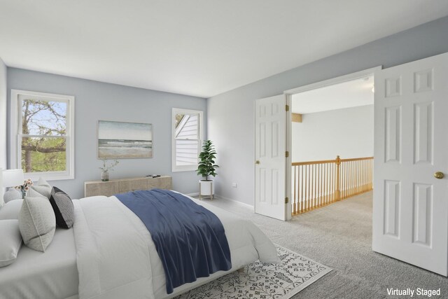 carpeted bedroom with multiple windows