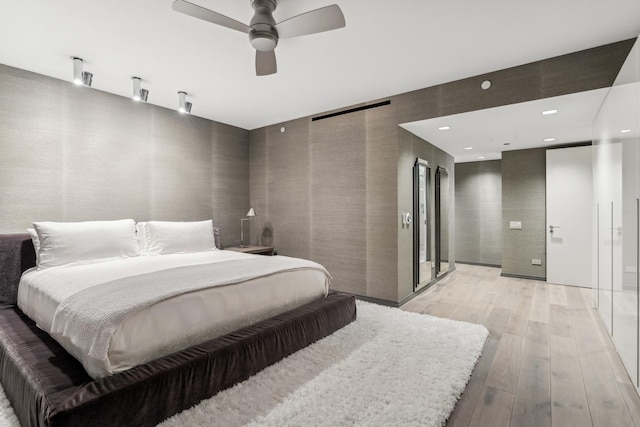 bedroom featuring wallpapered walls, light wood-style flooring, ceiling fan, and recessed lighting