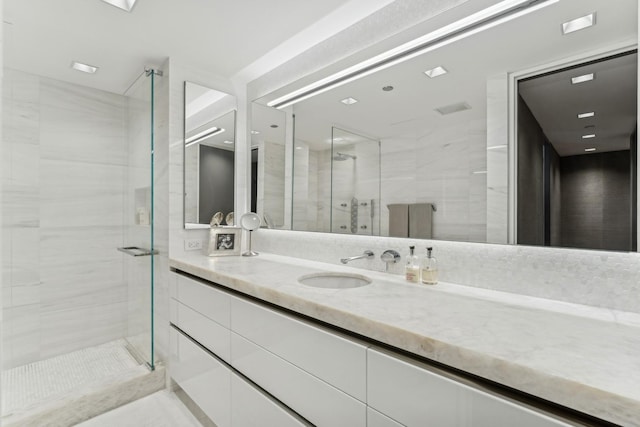 full bath with a stall shower and vanity