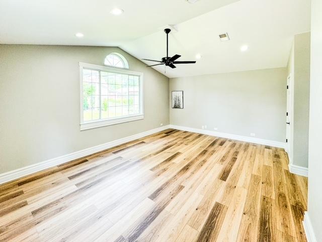 13110 W Playfield Dr, Crestwood, IL 60418 - empty room with ceiling fan, light wood-type flooring, lofted ceiling, and recessed lighting