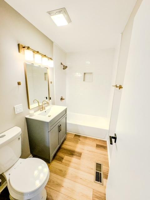 13110 W Playfield Dr, Crestwood, IL 60418 - full bathroom with vanity, wood finished floors, and shower / tub combination