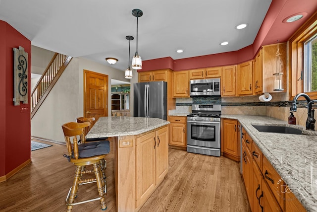 2527 Ryan Ct, Naperville, IL 60564 - kitchen featuring stainless steel appliances, a sink, light wood-type flooring, tasteful backsplash, and light stone countertops
