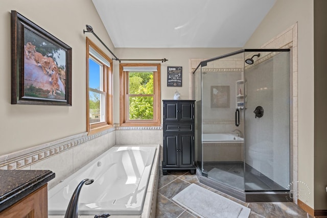2527 Ryan Ct, Naperville, IL 60564 - full bathroom with a garden tub, a shower stall, vaulted ceiling, vanity, and tile walls
