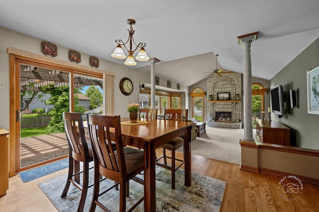 2527 Ryan Ct, Naperville, IL 60564 - dining room featuring a ceiling fan, a fireplace, vaulted ceiling, ornate columns, and light wood-style floors