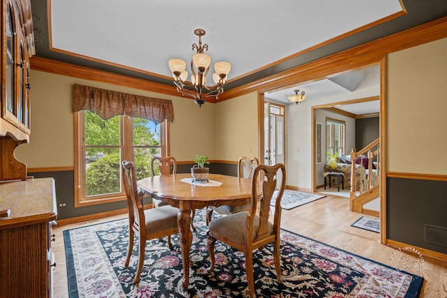 2527 Ryan Ct, Naperville, IL 60564 - dining space featuring crown molding, a chandelier, baseboards, and light wood-type flooring