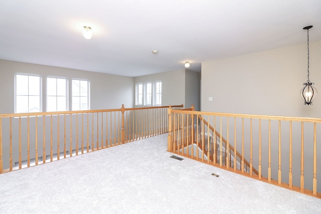 unfurnished room featuring visible vents and carpet