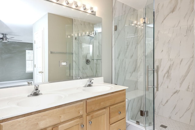 full bath featuring a ceiling fan, a marble finish shower, and a sink