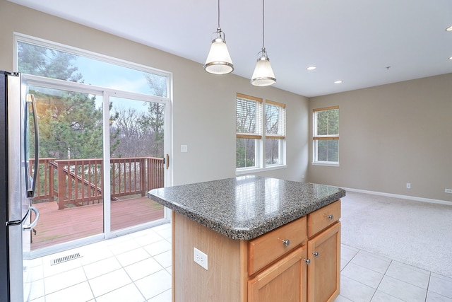 kitchen featuring plenty of natural light, visible vents, freestanding refrigerator, recessed lighting, and light tile patterned flooring