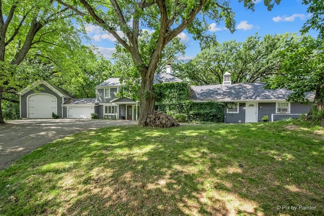 144 Algonquin Rd, Barrington Hills, IL 60010 - view of front of property featuring a garage, a front yard, asphalt driveway, and a chimney