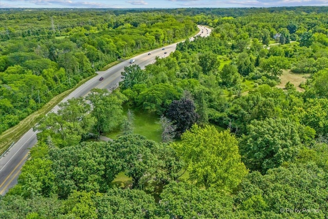 drone / aerial view with a wooded view