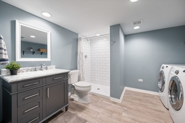 231 W Hickory Rd, Lombard, IL 60148 - bathroom with independent washer and dryer, a tile shower, vanity, wood finished floors, and recessed lighting