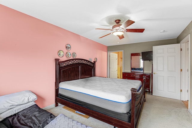 bedroom featuring a ceiling fan, baseboards, and light colored carpet