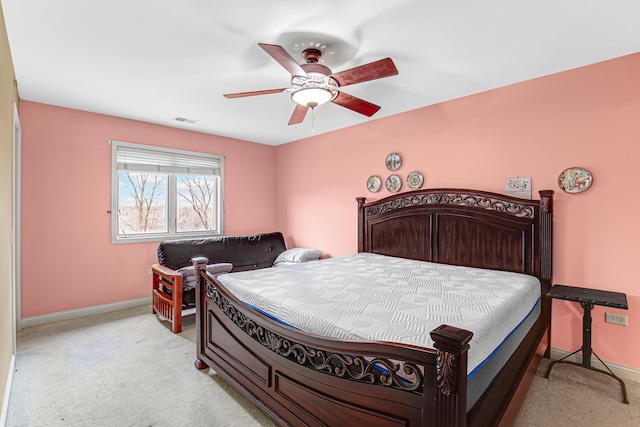 bedroom featuring baseboards, ceiling fan, visible vents, and light colored carpet