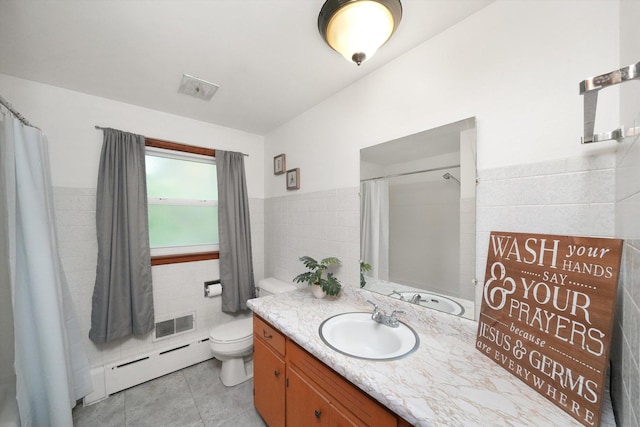 bathroom with visible vents, tile patterned flooring, baseboard heating, and tile walls