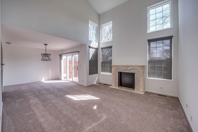 3924 Garnette Ct, Naperville, IL 60564 - unfurnished living room featuring a high ceiling, a high end fireplace, baseboards, and carpet floors