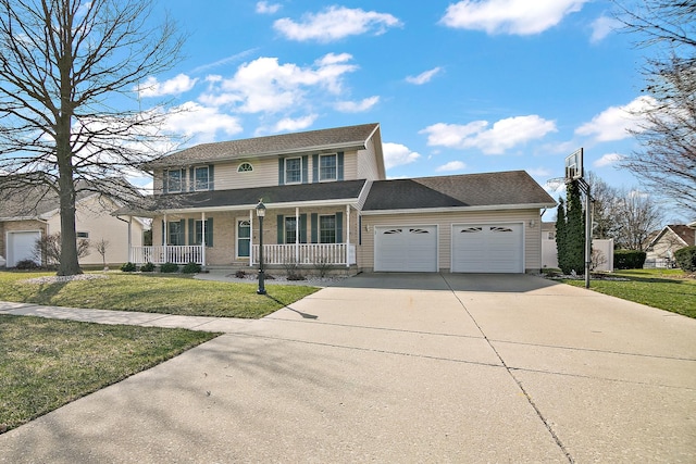 909 Revere St, Bourbonnais, IL 60914 - view of front of home with a front yard, a porch, a garage, and concrete driveway